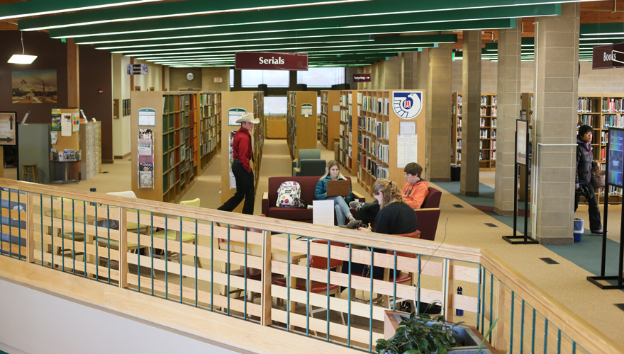 Students sitting on couches and studying on the second floor of Hinckley Library