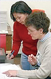 Carolyn White assists a student