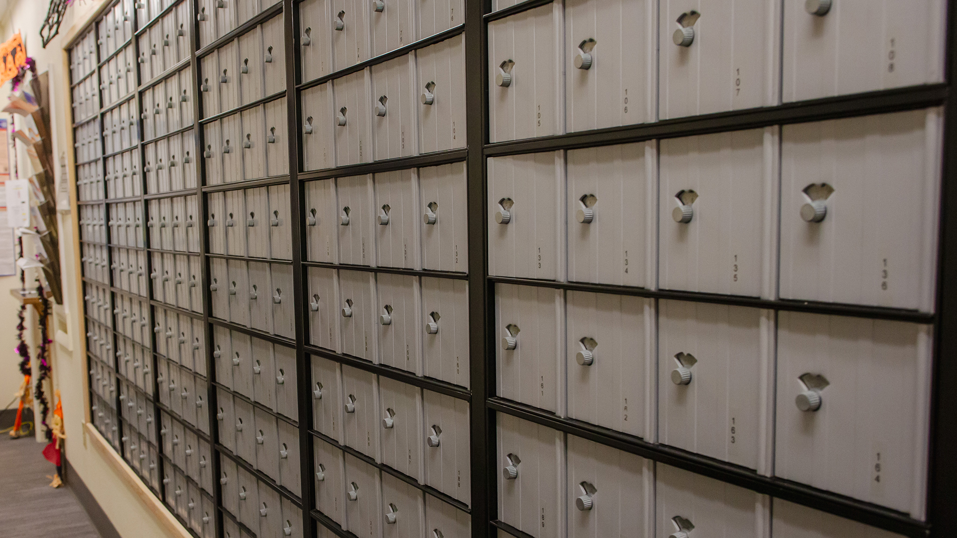 A wall of post office boxes inside a post office