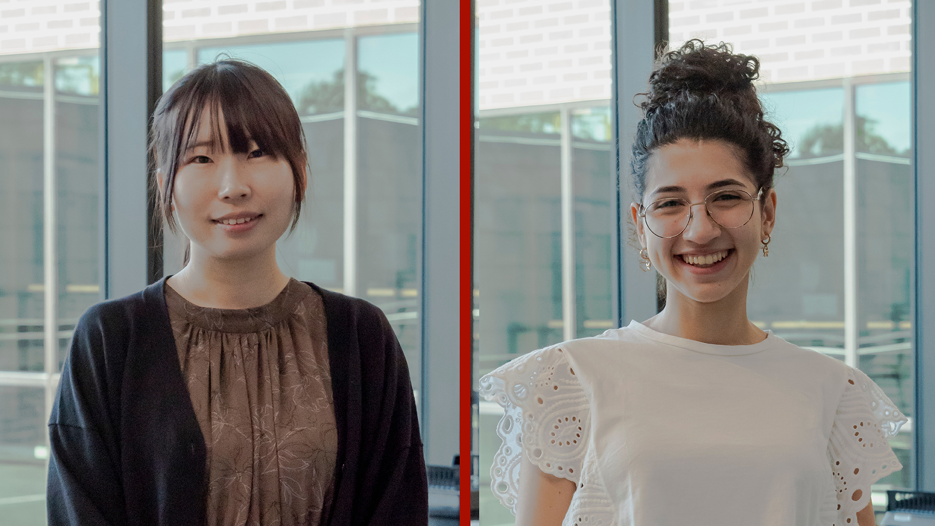 Two women standing side by side in front of windows, an Japanese female on the left and Argentinian female on the right wearing glasses