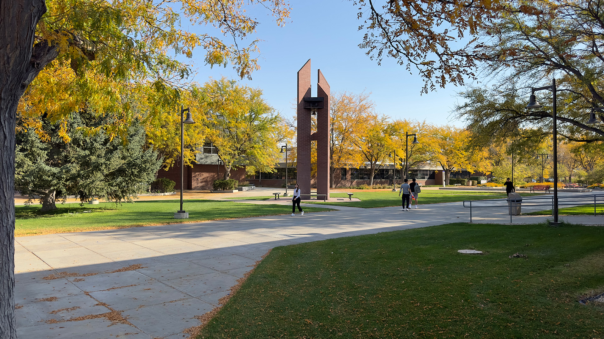 Fall afternoon with yellow and green leaves along sidewalks and a carillon