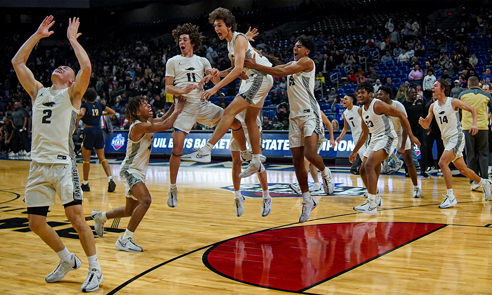 Boy's basketball players celebrating on the court