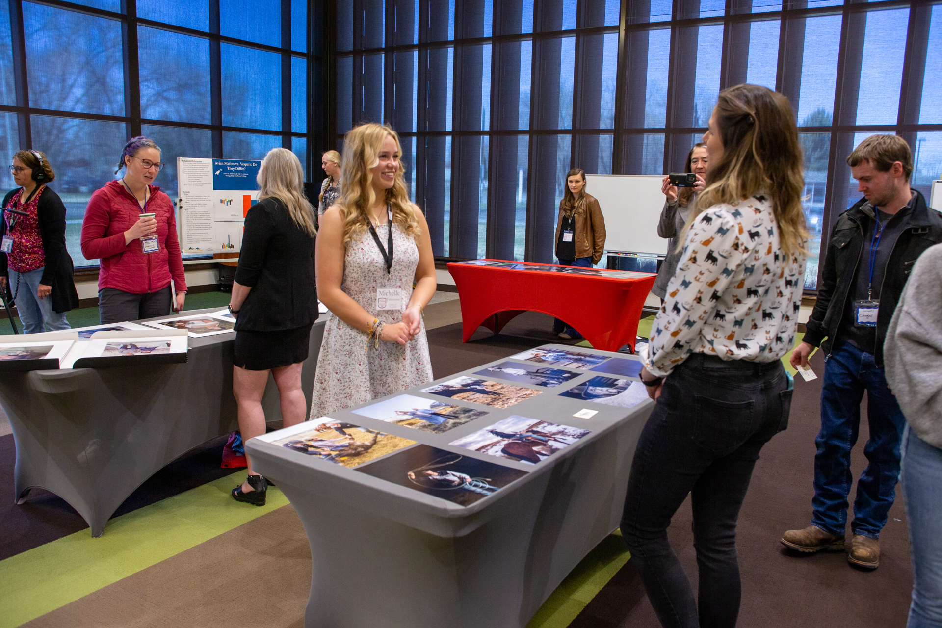 Female student at a table with photography work