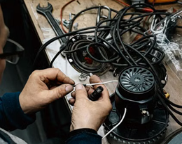 Hands working on a small engine